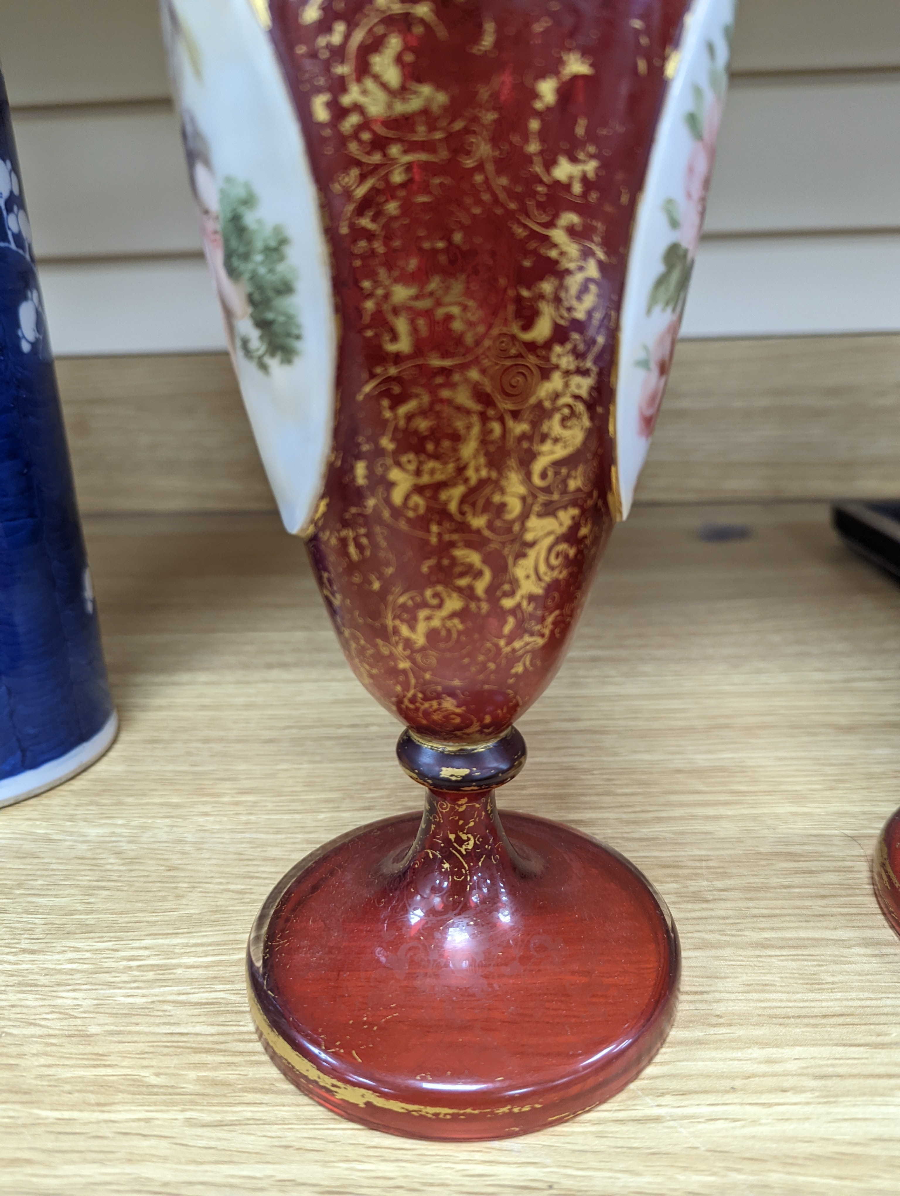 A pair of 19th century Bohemian enamelled and overlaid ruby glass vases 36cm